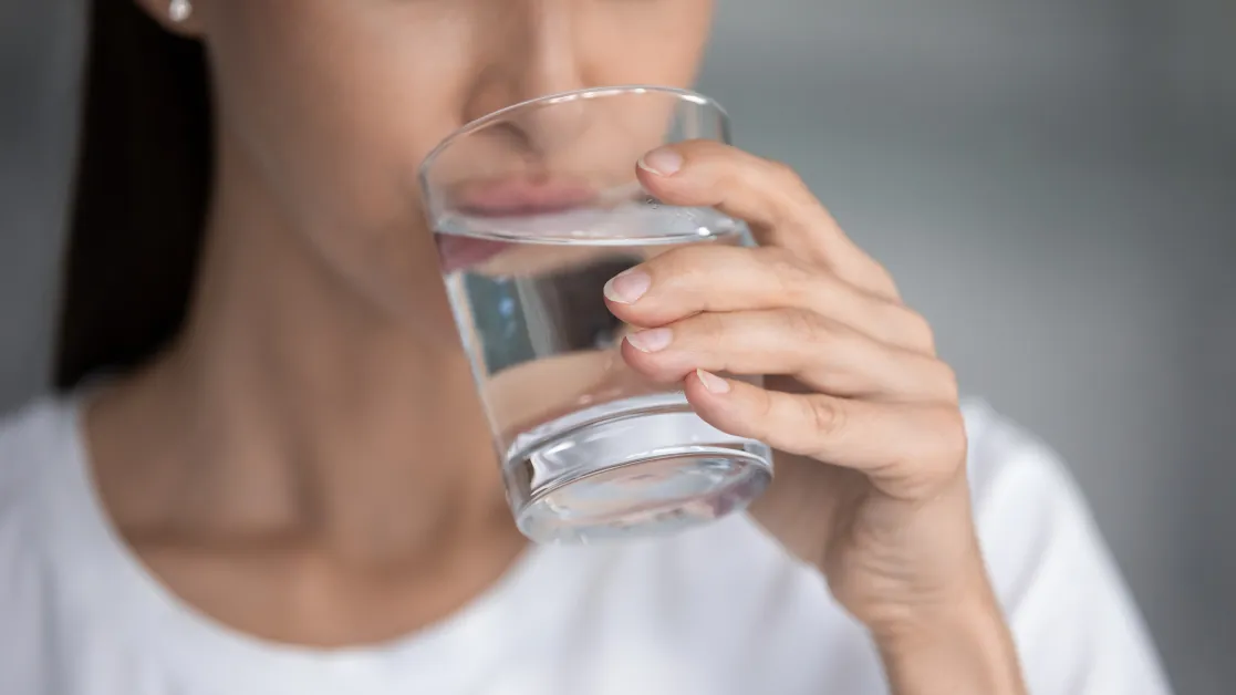 Person drinking a glass of water